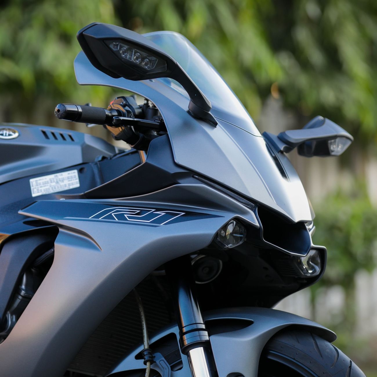 Close-up of a modern motorcycle emphasizing sleek design and chrome details.